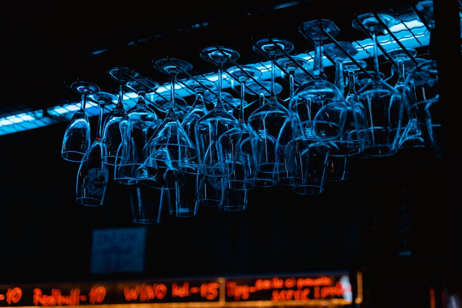 People enjoying entertainment event with blue lighting and drinks